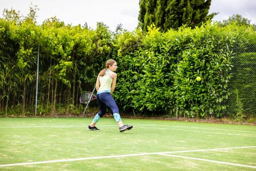 a woman is playing tennis on a tennis court at Domaine de la Tortinière in Montbazon