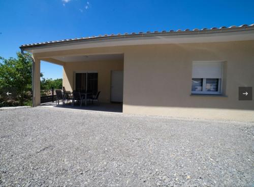 a view of a house with a patio at Gite LES BOUCHES ROUGES avec piscine privée in Vesseaux