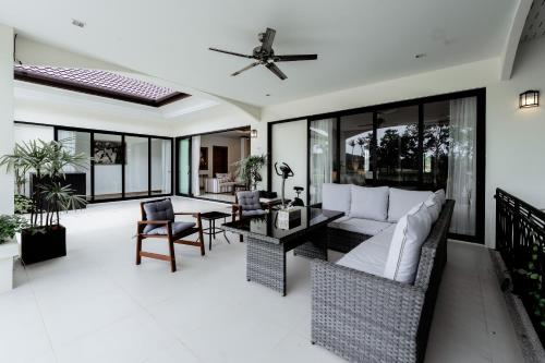 a living room with a couch and a table at Villa Viola 7 Bedroom, Fully Staffed, on the Golf Course in Laguna Phuket
