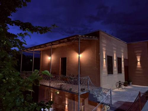 a house with a deck at night with lights at Veranda Boutique Hotel Kutaisi in Kutaisi