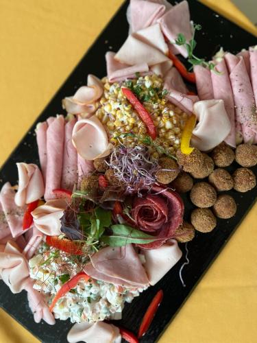 a plate of food with different types of food at Hotel Szieszta in Sopron