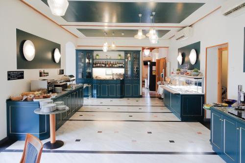 a large kitchen with blue cabinets and a counter at Hotel Villa Adriana in Monterosso al Mare