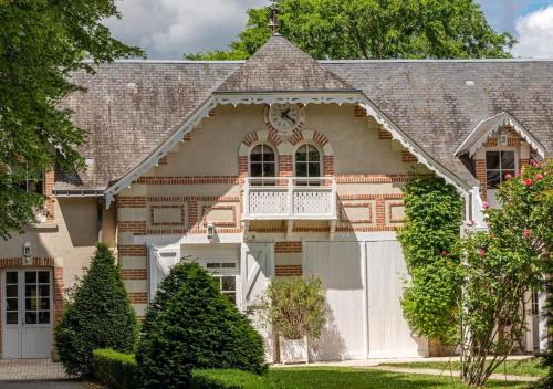 a large house with a white garage at Domaine de la Tortinière in Montbazon