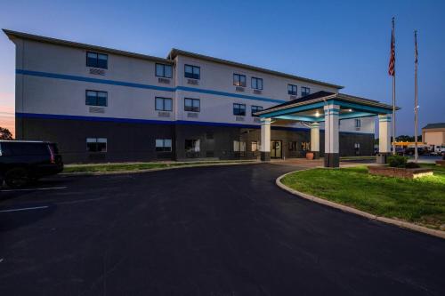 a building with a car parked in front of it at Days Inn by Wyndham Collinsville St Louis in Collinsville