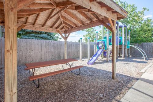 a playground with a bench and a slide at Super 8 by Wyndham Houghton Lake in Houghton Lake