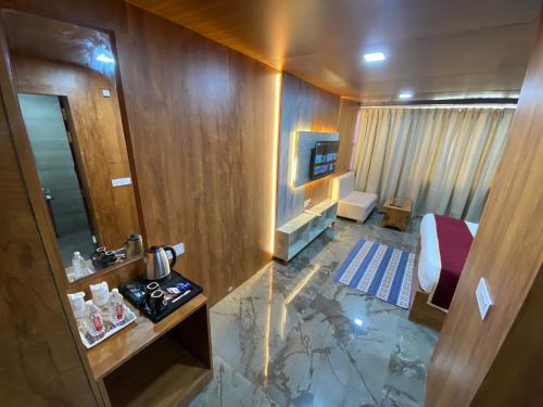 a bathroom with a sink and a toilet in a room at Rich Grand Hotel in Agra