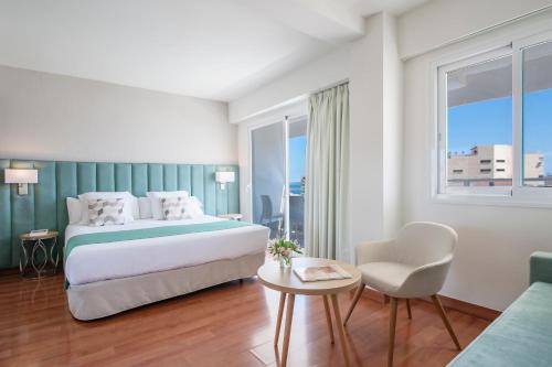 a hotel room with a bed and a chair at Hotel Costa Málaga - Adults Recommended - by Pierre & Vacances in Torremolinos