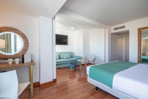 a hotel room with a bed and a mirror at Hotel Costa Málaga - Adults Recommended - by Pierre & Vacances in Torremolinos