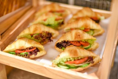 a group of sandwiches in a wooden tray at Atour X Hotel West Nanjing Road in Shanghai