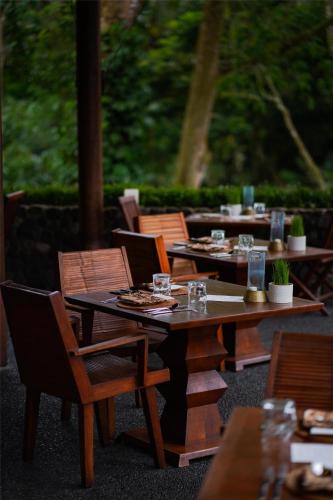 a group of tables and chairs with glasses on them at Alila Ubud in Ubud