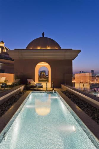 a swimming pool on the roof of a building at Marsa Malaz Kempinski, The Pearl in Doha