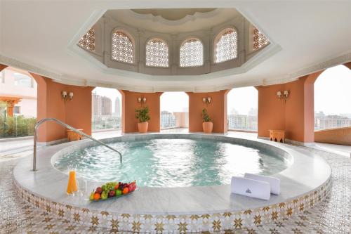 a pool in the middle of a building at Marsa Malaz Kempinski, The Pearl in Doha