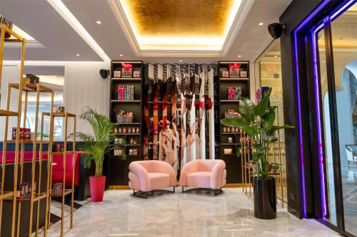 a store with two pink chairs in a room at Marsa Malaz Kempinski, The Pearl in Doha