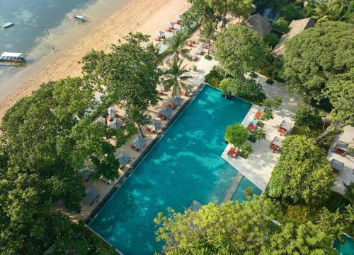 an overhead view of a swimming pool next to a beach at Andaz Bali, By Hyatt in Sanur