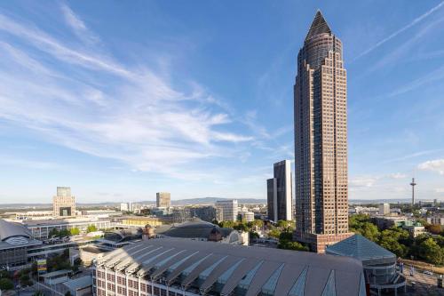 a tall skyscraper with a view of a city at nhow Frankfurt in Frankfurt/Main