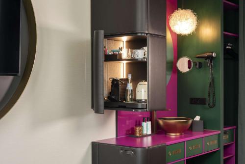 a bathroom with a purple counter and a sink at nhow Frankfurt in Frankfurt/Main