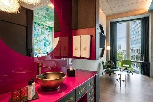 a kitchen with a bowl on a pink counter at nhow Frankfurt in Frankfurt/Main