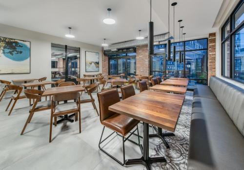 a row of tables and chairs in a restaurant at Hyatt Place Newark-Main Street in Newark