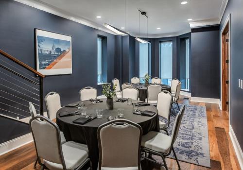 a boardroom with a table and chairs in a room with blue walls at Hyatt Place Newark-Main Street in Newark