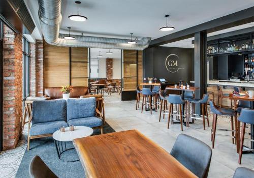 a restaurant with tables and chairs and a bar at Hyatt Place Newark-Main Street in Newark