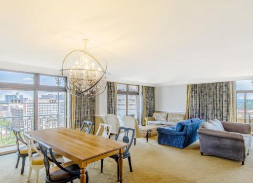 a living room with a table and chairs at Hyatt Regency Harare The Meikles in Harare