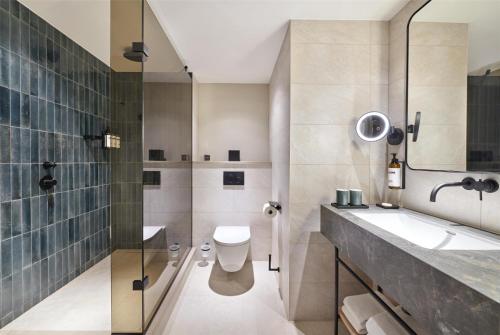a bathroom with a toilet and a sink at Hyatt Regency London Blackfriars in London