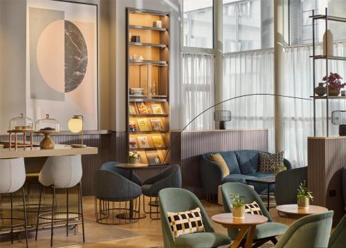 a restaurant with chairs and tables in a room at Hyatt Regency London Blackfriars in London