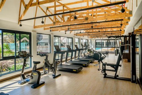 a gym with a row of treadms and cardio machines at Hyatt Regency Harare The Meikles in Harare
