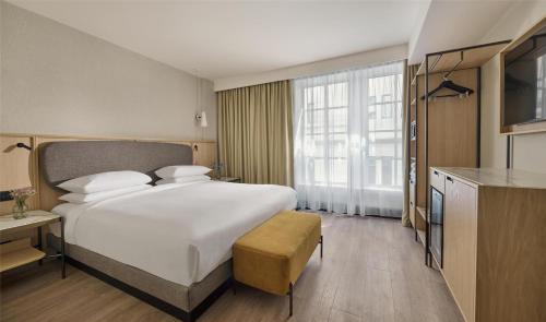 a hotel room with a large bed and a kitchen at Hyatt Regency London Blackfriars in London
