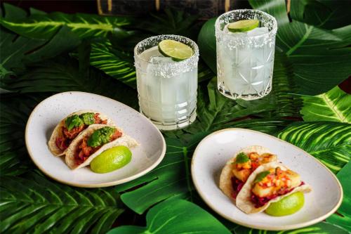 two plates of food and two glasses of water at Hyatt Regency London Blackfriars in London