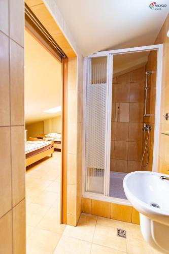 a bathroom with a shower and a sink at Tani skosik w MOSiRze in Sanok