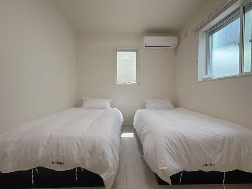Postel nebo postele na pokoji v ubytování Sanmi 天下茶屋1号馆