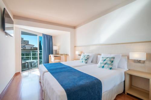 a hotel room with a bed and a large window at Hotel Costa Málaga - Adults Recommended - by Pierre & Vacances in Torremolinos