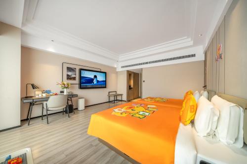 a hotel room with a large orange bed and a desk at Atour Hotel Chengdu Taikoo Li Riverside in Chengdu