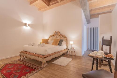 a bedroom with a large bed with a wooden headboard at Luxury Apartments in Villa Cardinal Ciceri by Rent All Como in San Fermo della Battaglia