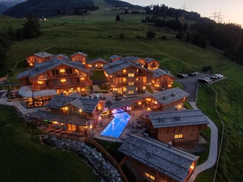 an aerial view of a resort with lights on at ZAGLGUT HOTEL-CHALETS Wellness & Views with Summer Card Included in Kaprun