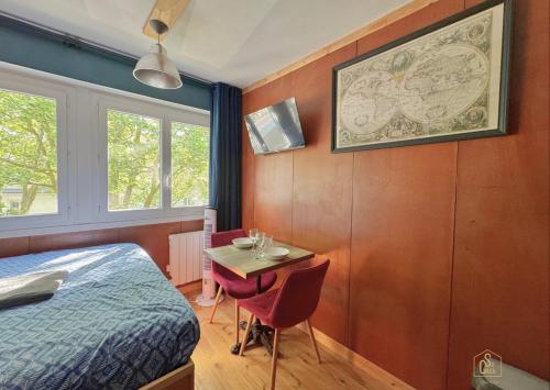 une chambre avec un lit et une table avec une petite table dans l'établissement Le Yacht - Elégant et optimisé, à Lorient