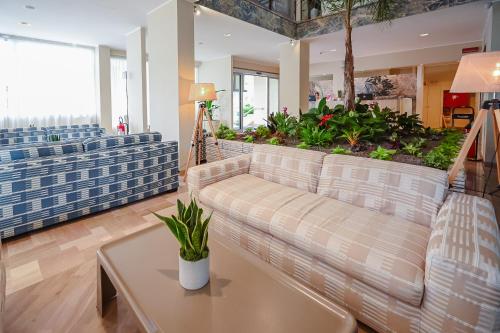 a living room with a couch and a table at Hotel Las Vegas in Lido di Jesolo