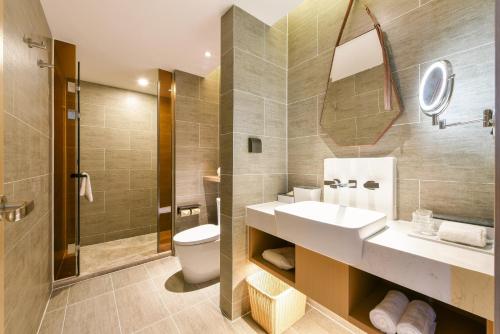 a bathroom with a sink and a toilet and a shower at Atour Hotel Beijing Tongzhou Liyuan Subway Station in Tongzhou
