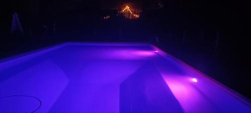 a tub with purple lights in a dark room at Antico Podere Il Bugnolo in Poggibonsi