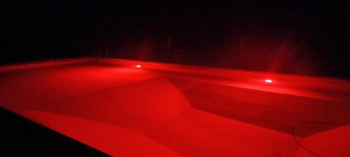 a room with red lights in the dark at Antico Podere Il Bugnolo in Poggibonsi