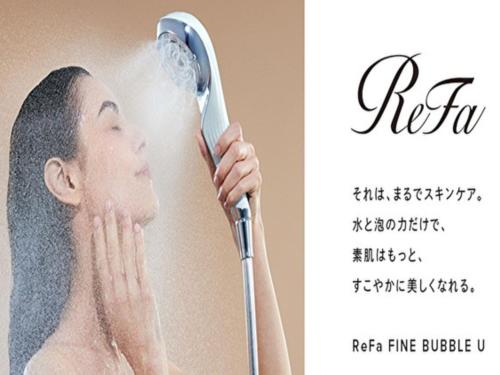 a man brushing his hair with a hairdryer at Minamisenri Crystal Hotel - Vacation STAY 78139v in Suita