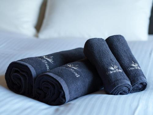 a pile of rolled towels on a bed at Minamisenri Crystal Hotel - Vacation STAY 74035v in Suita