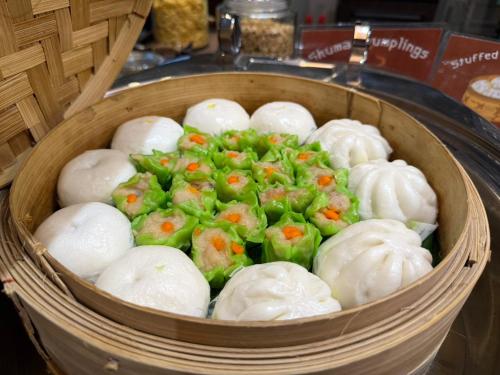 a basket full of dumplings with carrots on them at Smile Lanna Hotel in Chiang Mai