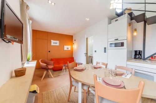 a dining room and kitchen with a table and chairs at Le Lanwezou - Petite maison - 2 à 4 personnes in Saint-Benoît-des-Ondes