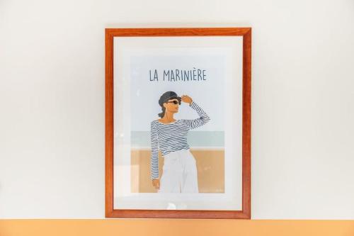une image encadrée d'une femme portant des lunettes de soleil dans l'établissement La Marinière - Terrasse et parking, proche plage, à Saint-Malo