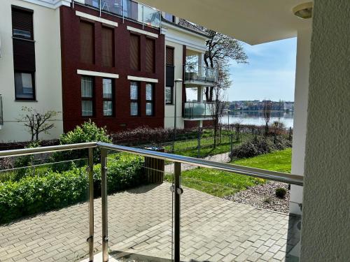 a balcony of a building with a view of the water at Lakeside Promenade View Studios in Ostróda