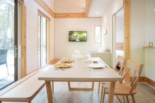 a dining room with a table and chairs at Re to Li - りとり - 一棟貸しの宿 in Tsumagoi