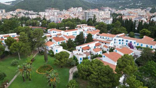 an aerial view of a village with houses and trees at Hotel Slovenska Plaza in Budva