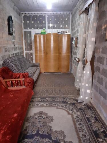 a living room with a couch and a wooden door at Vacation Home in Ashtarak in Ashtarak